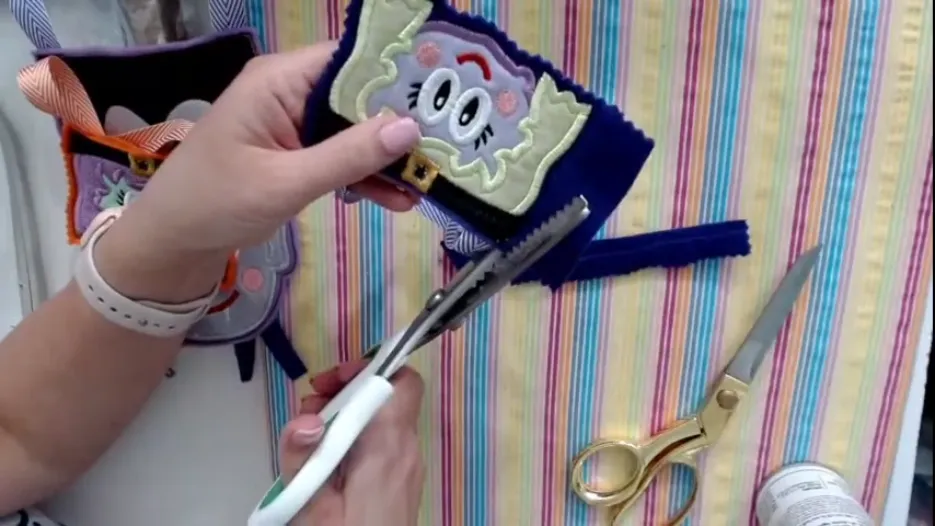 finishing touches in Brother Embroidery Machine Tutorial Halloween with bag