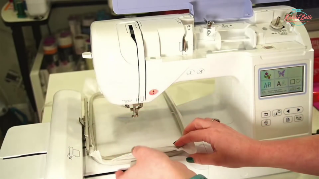 Threading the embroidery machine with green thread